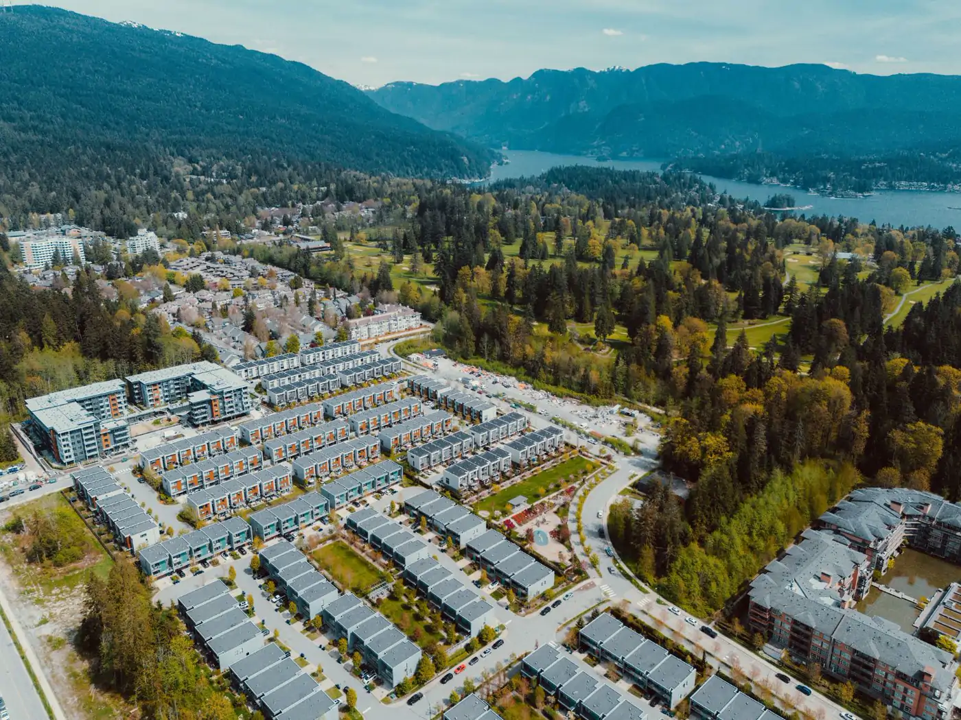 Aerial view of Seymour Village in North Vancouver with Indian Arm and the North Shore mountains behind